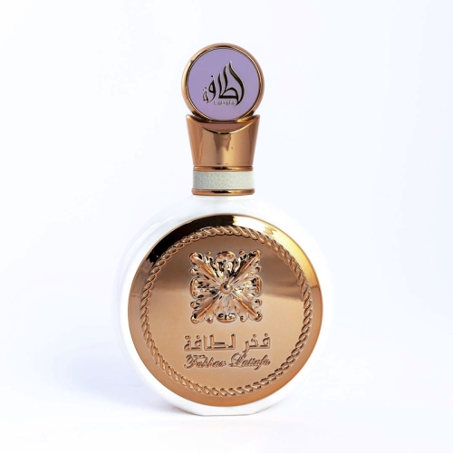 legancka buteleczka perfum damskich Fakhar Lattafa 100 ml z ozdobnym korkiem i złotymi akcentami, na tle eleganckiej powierzchni